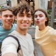 guy takes selfie with friends